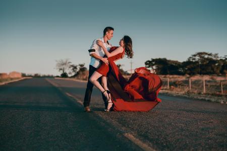 Man and Woman Doing Dance Post in Concrete Road at Daytime