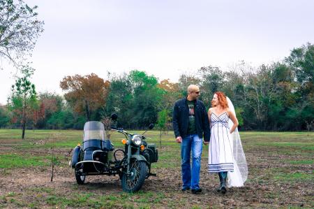 Man and Woman Holding Each Other Hand Beside Grey Motorcycle With Side Trailer
