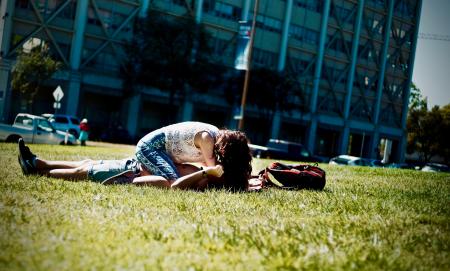 Man and Woman Lying on Green Field