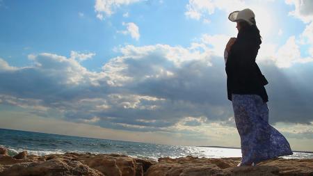 Man and Woman Wearing Jackets Near Seaside Under Cloudy Sky
