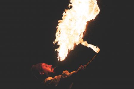 Man Blowing Fire during Nighttime