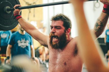 Man Carrying Black Barbell