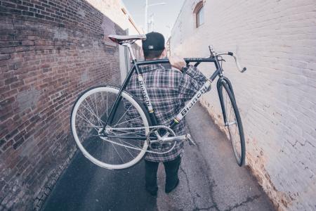 Man Carrying White And Black Bianchi Road Bike