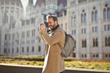 Man Holding and Capturing Images Around Him