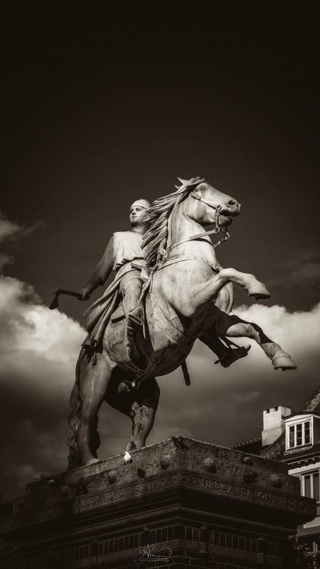 Man Holding Axe Rides On Horse Concrete Statue