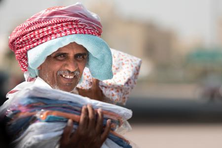 Man Holding Clothing While Smiling