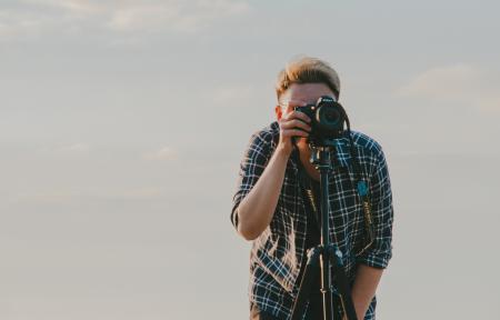 Man Holding Dslr Camera With Tripod