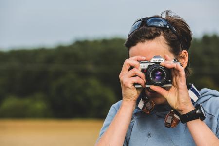 Man Holding Gray and Black Dslr Camera