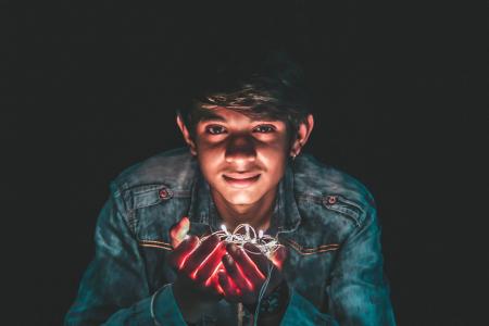 Man Holding White String Light Photo