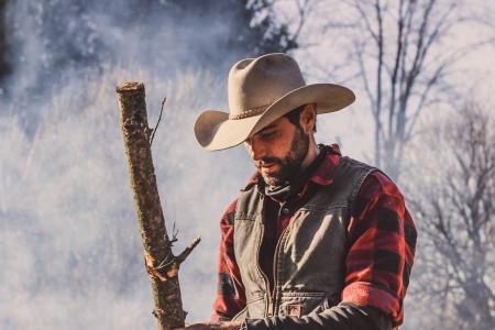 Man Holding Wood Standing