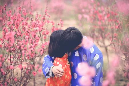 Man Hugging Girl in Orange Clothes