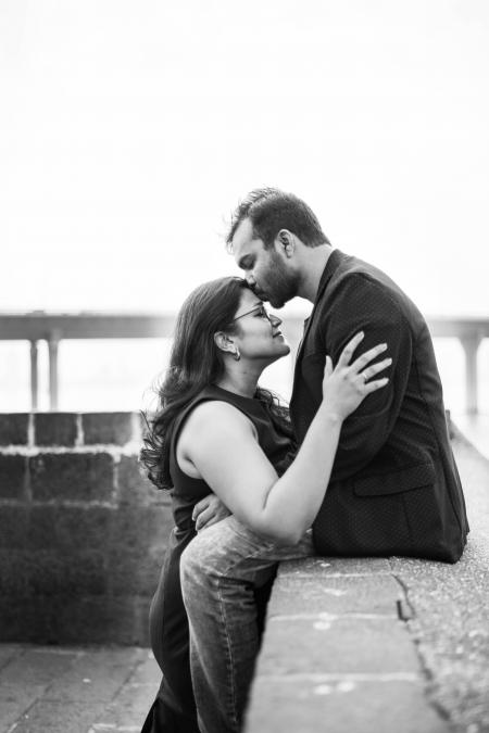 Man In Black Coat Sitting While Kissing Woman