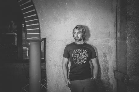 Man in Black Crew-neck T-shirt Beside Wall