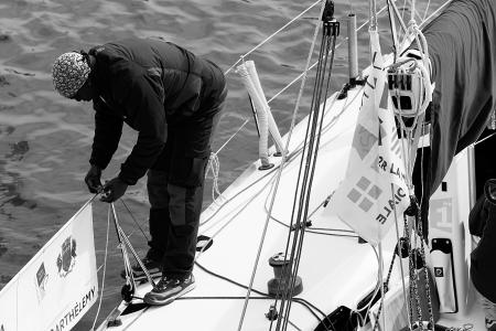 Man in Black Gray Jacket on a Boat's Railing