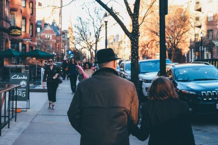 Man in Black Hat Holding His Wife