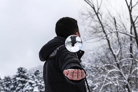 Man in Black Hoodie during Snow Weather at Daytime