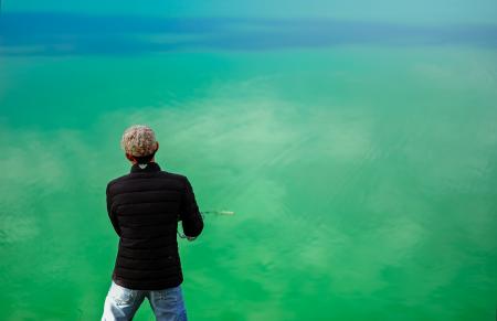 Man in Black Jacket Standing in Front of Sea