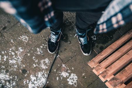 Man in Black Jeans Wearing Pair of Vans Old Skool Sk8-hi