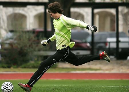 Man in Black Pants Playing Soccer during Daytime