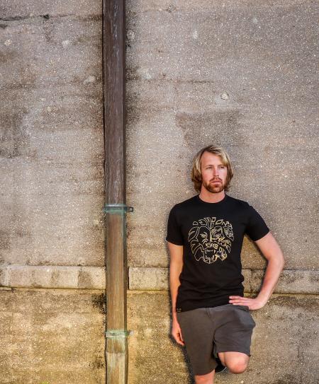 Man in Black Shirt and Bermuda Shorts