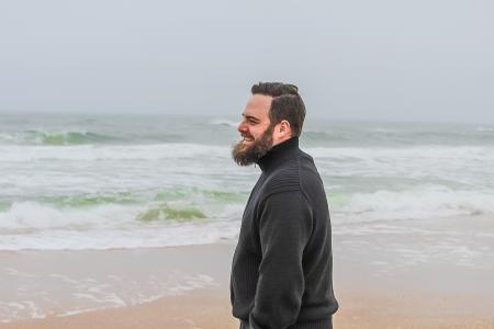 Man in Black Turtle-neck Jacket Standing on Shore