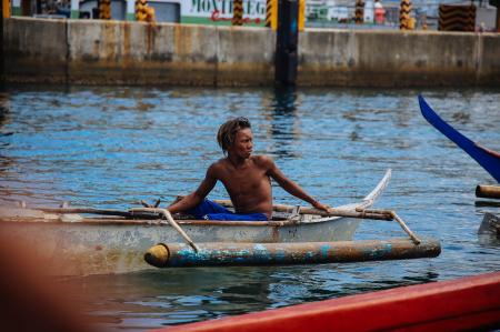 Man in Blue Shorts on Gray Boat