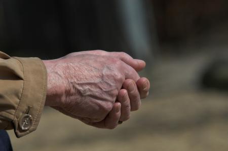 Man in Brown Dress Shirt Clasp Both Hands