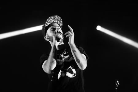 Man in Crew Neck Shirt Holding a Microphone