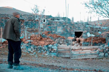 Man in Gray Jacket Standing on Rocks