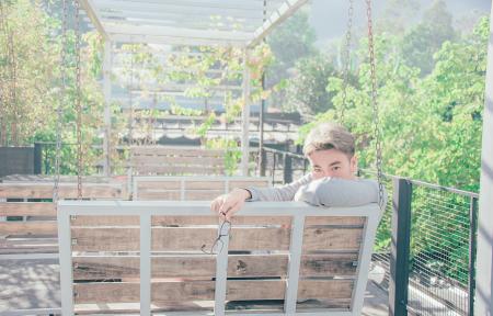 Man in Gray Shirt Sitting on Bench