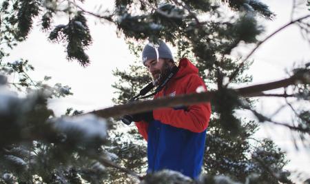 Man in Red and Blue Jacket Near Trees