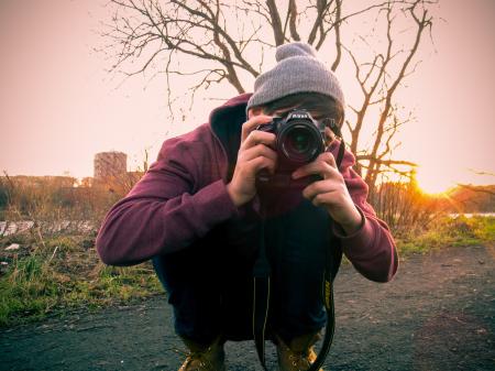 Man in Red Jacket Holding Black Dslr Camera