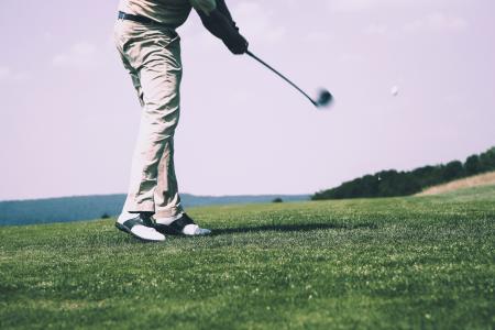 Man in White Denim Pants and Black Sandals Playing Golf during Daytime