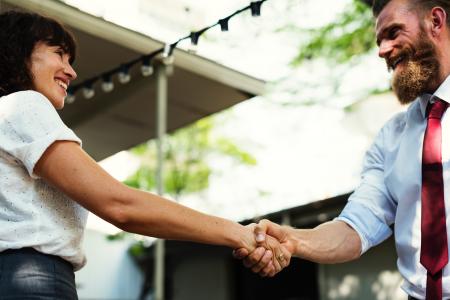 Man In White Dress Shirt And Maroon Neck Tie Shaking Hands With Girl In White Dress