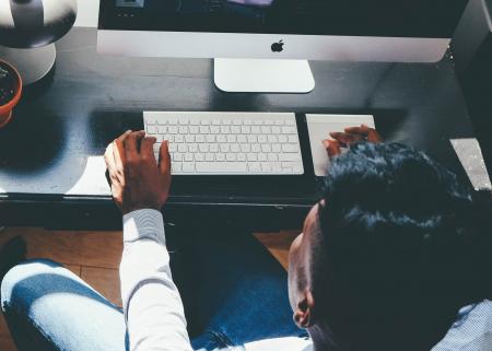 Man in White Dress Shirt Facing Turned on Silver Imac