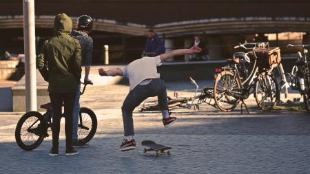 Man in White Shirt Doing Skateboard Trick