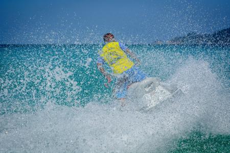 Man in Yellow Shirt Using Personal Watercraft