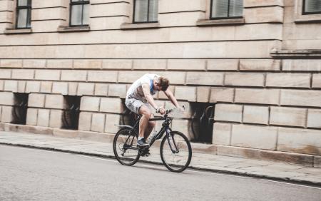 Man Riding Black Mountain Bike on Pathway during Daytime