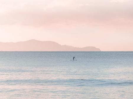 Man Rowing a Boat on Sea at Daytime