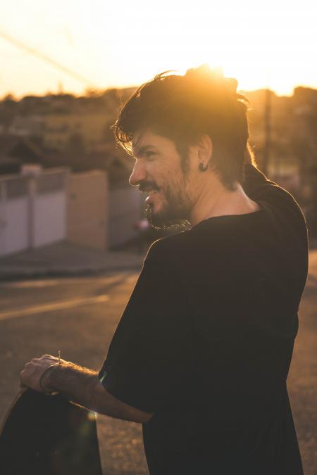 Man Scratching His Head during Sunset