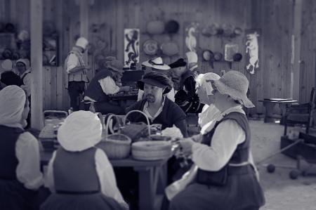 Man Sitting Between Female Near Table