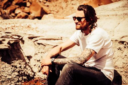 Man Sitting in Brown Stone