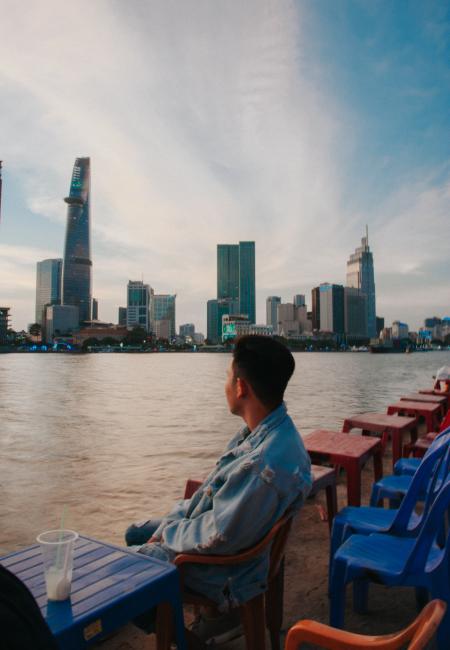 Man Sitting in Front of Body of Water