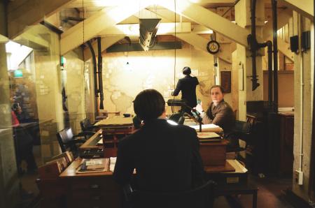 Man Sitting on Chair Leaning on Table