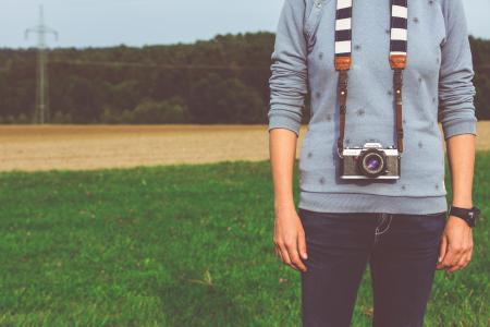 Man Standing Carrying Dslr Camera during Daytime