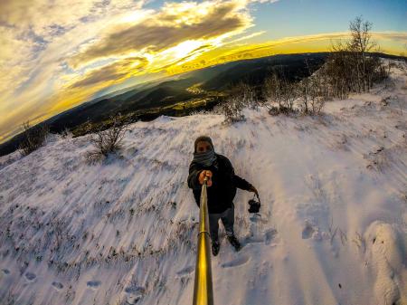 Man Standing on Snowy Terrain