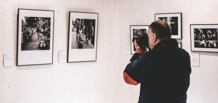 Man Taking Photo Inside Exhibit Room