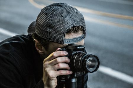 Man Taking Photo Using Black Canon DSLR Camera