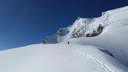 Man Walking in White Mountain Snow during Daytime