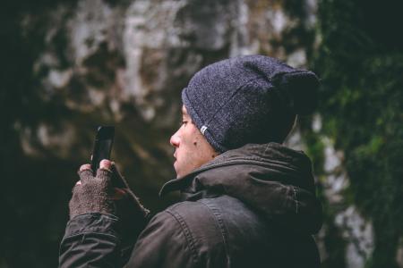 Man Wearing Beanie Holding Smartphone